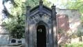 Walking into a tomb/mausoleum in a graveyard and looking down an empty grave HD Footage