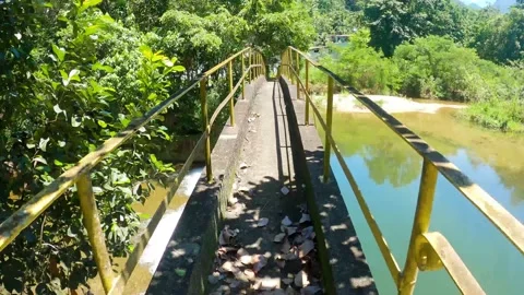 Walking on top of suspension bridge over water dam. Walk along the bridge Stock Footage 168708128