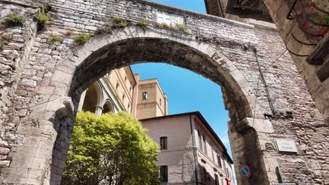 Walking tour through medieval archways and narrow streets in Assisi Italy Stock Footage 338009281