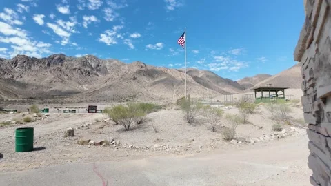 Walking Toward American Flag in Las Vegas Desert Under Clear Sky Stock Footage 318616635