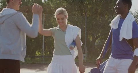 Walking toward coach waving diverse tennis teammates using tablet for tactics on 库存影片 344338161