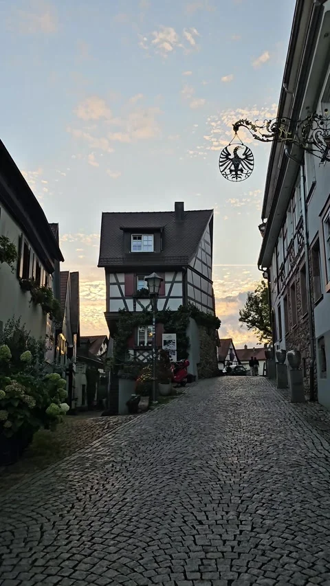 Walking Toward Half-Timbered House on Cobblestone Street at Sunset Vídeo Stock 344311964