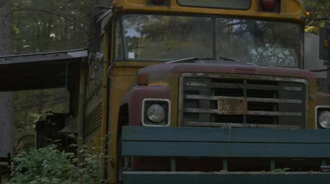 Walking towards abandoned school bus in woods to lens flare- creepy Stock Footage 58120985