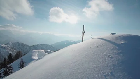 Walking towards a cross monument on top of a snowy mountain  Stock Footage 102572259