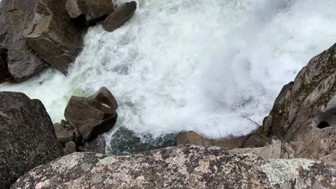 Walking Towards the Edge of a Cliff Over a Waterfall Stock Footage 131988621