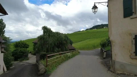 Walking towards grape vineyards from small rustic old village in Switzerland Stock Footage 164231942