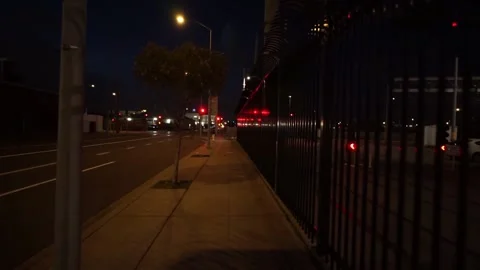 Walking towards red traffic light at junction at night Stock Footage 236812357