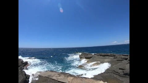 Walking Towards Rocky Shore with Deep Blue Sea View Stock Footage 333697191