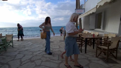 Walking towards the seafront and beach in Agios Nikitas Stock Footage 244842707