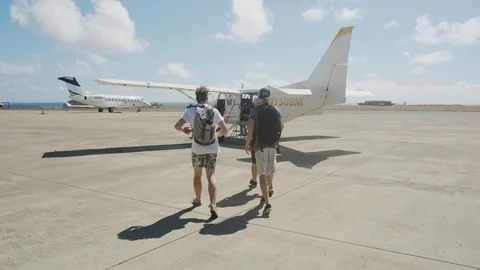 Walking Towards Small Plane Stock Footage 75276560