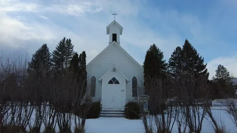 Walking towards small snow covered church in the country Stock Footage 167868012