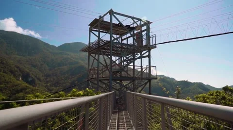 Walking towards zip line tower in hills Video stock 67600362
