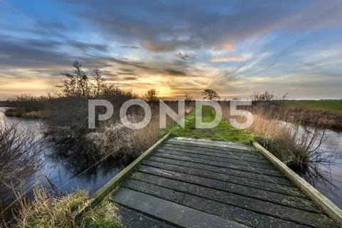 Walking track with bridge at sunset Stock Photos