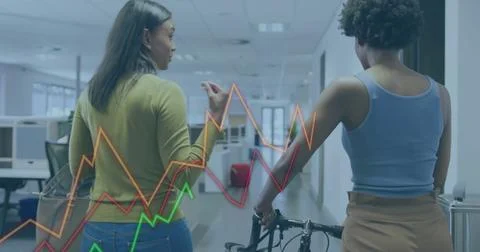 Walking two colleagues discussing data in open office corridor, holding bicycle, Stock Photos