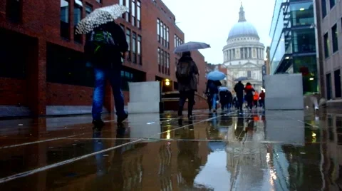 Walking with umbrellas in the rain Stock Footage 67686005