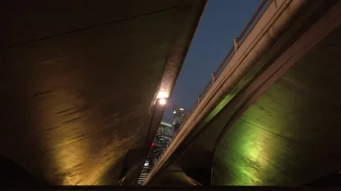 Walking under bridge and look up to bridge with modern office high rise sky.. Stock Footage 311058072