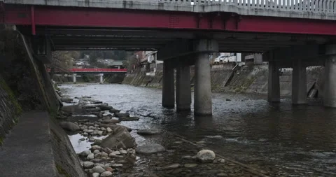 Walking under the bridge, small mountain river in the city. Traditional historic Stock Footage 135219828