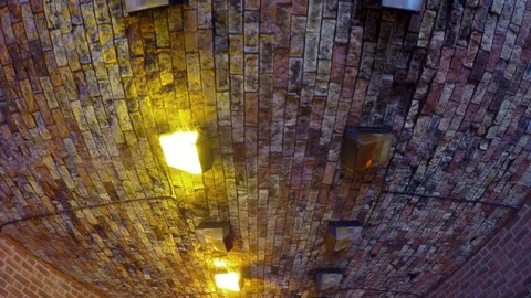 Walking under broken lights in a passage in London Stock Footage 79929730