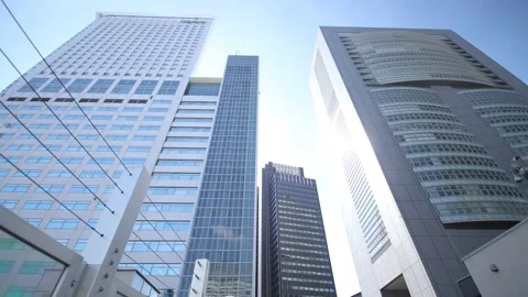 Walking under the building in Tokyo Japan. Shinjuku skyscraper. Dolly back. Stock Footage 220098529