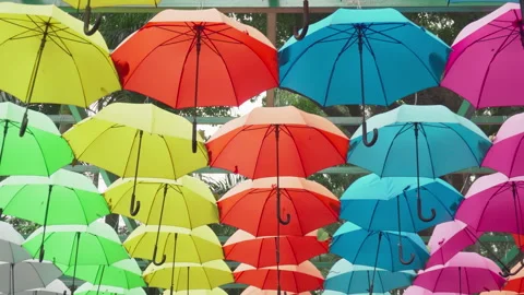Walking under canopy of umbrellas in a park. Garden decor Stockbeeldmateriaal 257226555