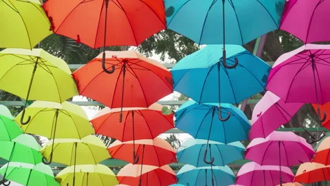 Walking under canopy of umbrellas in a park. Garden decor Stockbeeldmateriaal 260369042