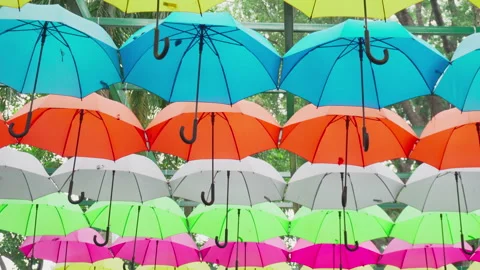 Walking under canopy of umbrellas in a park. Garden decor Stockbeeldmateriaal 264265442
