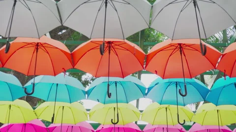 Walking under canopy of umbrellas in a park. Garden decor Stockbeeldmateriaal 272558779