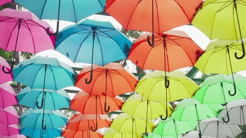 Walking under canopy of umbrellas in a park. Garden decor Stock Footage 276300963