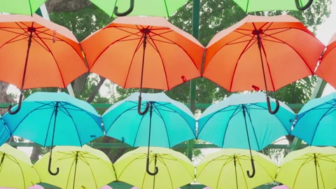 Walking under canopy of umbrellas in a park. Garden decor Stockbeeldmateriaal 283161163