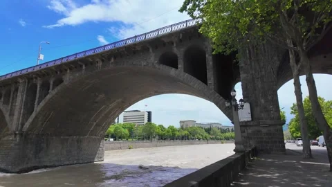 Walking under the galaktioni bridge over mtkvari river in tbilisi Stock-Footage 337889901