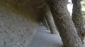 Walking under the interesting arcade of stone columns in Park Guell, Barcelona 4k or 4k+ Resolution