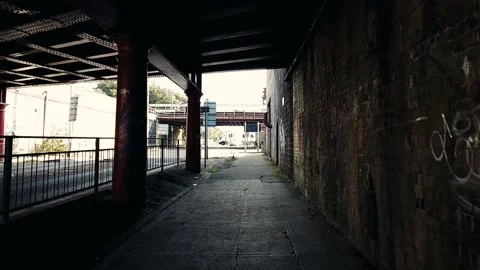 Walking under a red railway bridge Stock Footage 160437909