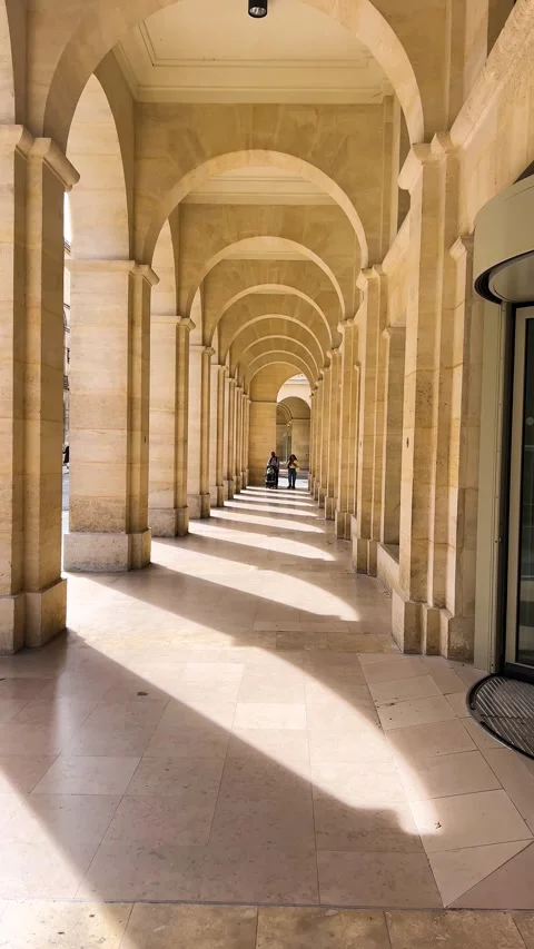 Walking under a sunlit arcade. Vertical video. Stock-Footage 311934064