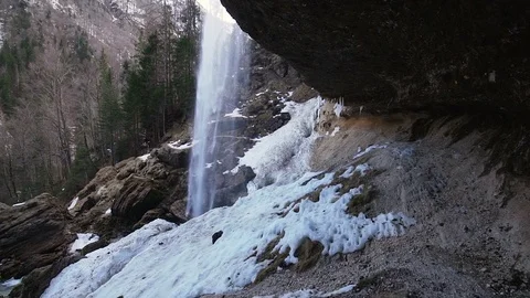 Walking under a waterfall flowing over a cliff Stock Footage 103221051