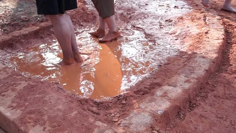 Walking in water in clay, reflection of the sun, outside Stock Footage 310591596
