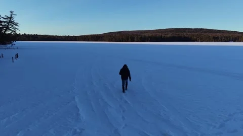 Walking in the winter on snow covered pond Video stock 329443757