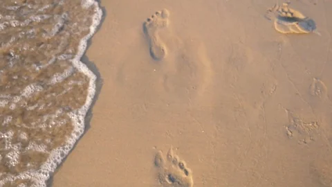 Walking woman, footsteps on the sea sand and sea waves Stock Footage