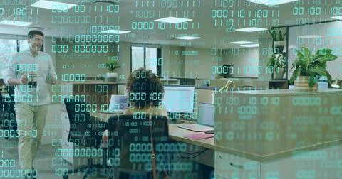 Walking worker with coffee mug passing female coder at dual monitors in office, Stock Photos