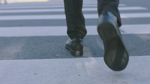 Walking on the zebra crossing in leather shoes Stock Footage