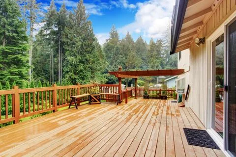 Walkout deck overlooking backyard landscape Stock Photos