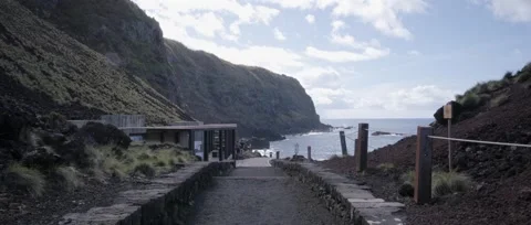 Walks along a path towards the Ponta da Ferraria thermal pools Stock Footage 320074086