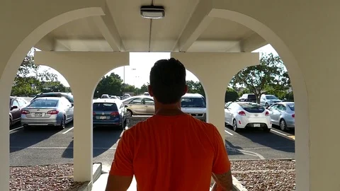 Walks Through Arch Stock Footage 123451060