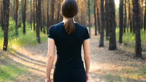 Walks trees forest sneakers shoes girl sun sport Stock Footage 110258853