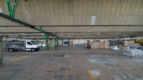 Walkthrough of long warehouse with various inventory, drone aerial 4K Stock Footage 101200760