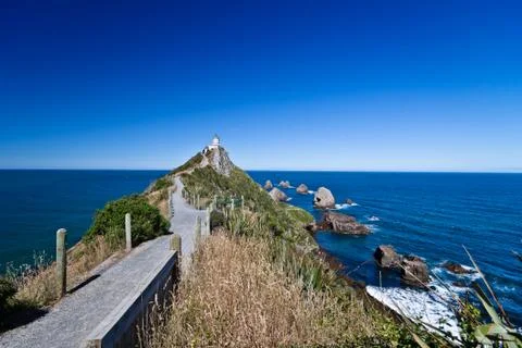 Walkway to lighthouse Stock Photos