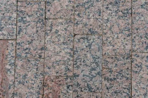 The walkway is made of rectangular granite tiles. Stock Photos