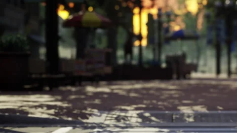 A walkway in a park shows shadows from trees as the sun sets Stock Footage 340017863