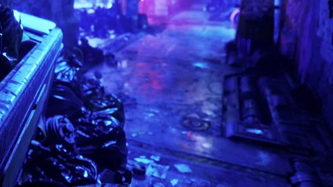 Walkway with trash and lighting effects in an urban setting at night Stock Footage 343927347