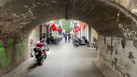 The walkway under the skytrain in Hanoi leads into old dormitories Stock Footage 264030558
