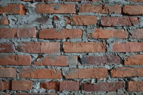 Wall of aged bricks and cement texture background image close up without peop Stock Photos
